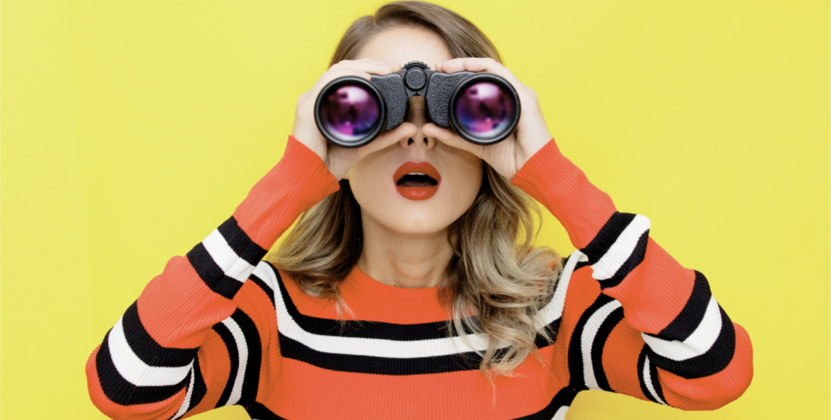 A woman looking through binoculars